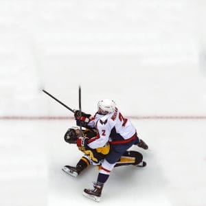 Pittsburgh Penguins' Sidney Crosby (87) takes a hit from Washington Capitals' Matt Niskanen during the first period of Game 3 in an NHL Stanley Cup Eastern Conference semifinal hockey game against the Washington Capitals in Pittsburgh, Monday, May 1, 2017. Crosby left the game and did not return. The Capitals won in overtime 3-2. (Gene J. Puskar/AP)