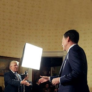 U.S. President Donald Trump greets Director of the FBI James Comey as Director of the Secret Service Joseph Clancy (L) watches during the Inaugural Law Enforcement Officers and First Responders Reception in the Blue Room of the White House in Washington, U.S., January 22, 2017. (Joshua Roberts/Reuters)
