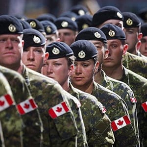 Members of the Canadian Armed Forces march during the Calgary Stampede parade in Calgary, Friday, July 8, 2016. The Defence Department says a painstaking review of dusty personnel files in the national archives may be needed to determine how many people were forced out of the military for being gay or lesbian. (Jeff McIntosh/CP)
