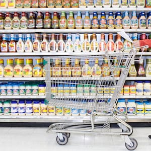 Shopper checking list in supermarket aisle