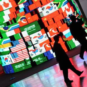 Delegation officials walk past a screen tower displaying the flags of the G20 member countries at the Seoul international convention, and venue of the G20 Summit, on November 12, 2010. Leaders of the Group of 20 on November 11 began the two-day fractious summit dominated by arguments over trade and currency policy. (Romeo Gacad/AFP/Getty Images)