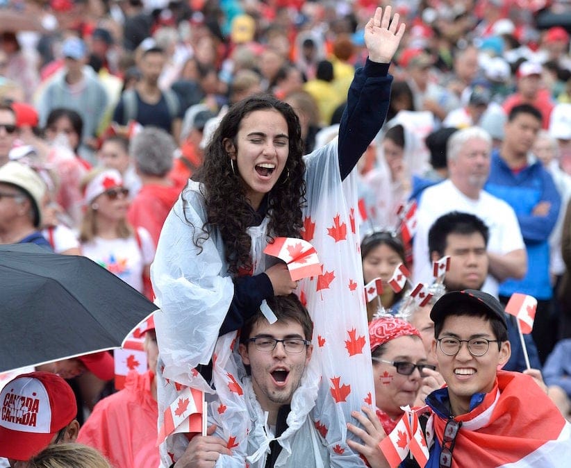 People cheer during the Canada Day noon hour show on Parliament Hill in Ottawa on Saturday, July 1, 2017. THE CANADIAN PRESS/Justin Tang
