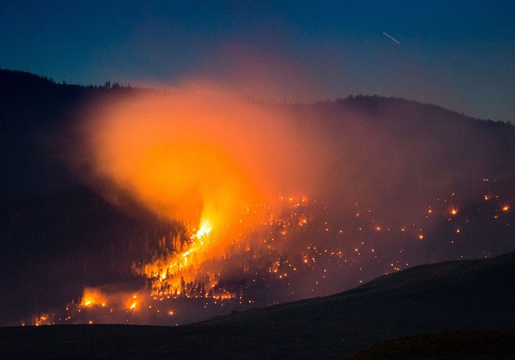 A wildfire burns on a mountain near Ashcroft, B.C., late Friday July 7, 2017. More than 3,000 residents have been evacuated from their homes in central British Columbia. A provincial state of emergency was declared after 56 new wildfires started Friday. (Darryl Dyck/CP)