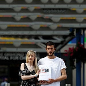 The parents of critically ill baby Charlie Gard, Connie Yates and Chris Gard, pose for the media with a petition, outside Great Ormond Street Hospital, in central London, Britain July 9, 2017. The parents want their son, who has a form of mitochondrial disease, to be able to travel to receive further treatment, after losing a long legal battle to give him experimental therapy in the United States. (Peter Nicholls/Reuters)