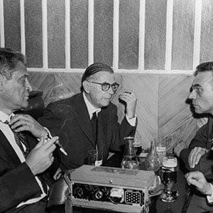 Writers Joseph KESSEL Jean-Paul SARTRE and, to the latter's right, the reporter Roger PRIOURET conversing at the close of reporter Georges ARNAUD's trial. ARNAUD was sentenced to a two year suspended prison sentence. The scene takes place in a Paris cafe near the military tribunal of Paris, on June 18, 1960. (Keystone-France/Gamma-Keystone/Getty Images)