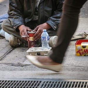TORONTO ON - Michael Manitowabie 42, panhandles on his corner at Richmond and Simcoe as he has done (according to him) for 20 years June 18, 2013.