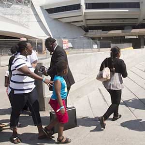Asylum seekers arrive at Montreal's Olympic Stadium (Peter Ray/CP)