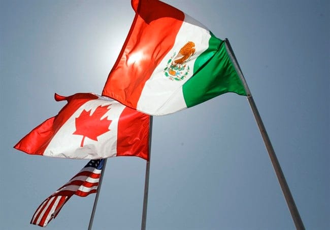 In this April 21, 2008 file photo, national flags of the United States, Canada, and Mexico fly in the breeze in New Orleans. Negotiations start Wednesday for an update to the quarter-century-old North American Free Trade Agreement. THE CANADIAN PRESS/AP/Judi Bottoni