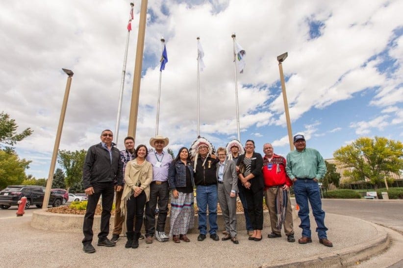 Representatives of Lethbridge College and Alberta Blackfoot Nations celebrate the new flag near the main entrance of campus (Submitted)