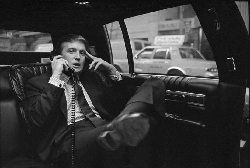 Donald Trump on the phone in his car after announcing plans for development of the west side of midtown Manhattan at the Hyatt Hotel on 42nd Street and Lexington Avenue, in New York, NY, November 18, 1985. (Neal Boenzi/The New York Times/Redux)