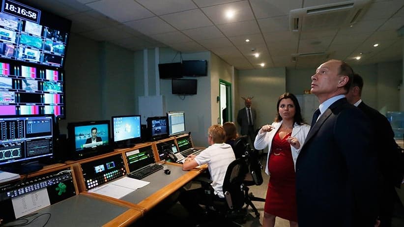 Russian President Vladimir Putin, right, visits the new headquarters of the Russia Today television channel in Moscow, Russia in June 2013