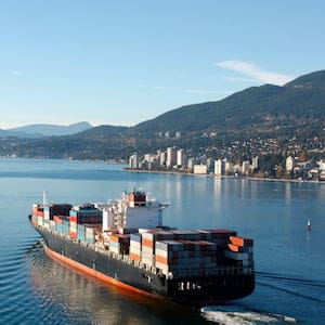Aerial photo of a loaded container ship leaving port.