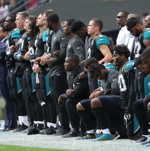 LONDON, ENGLAND - SEPTEMBER 24: Jacksonville Jaguars players kneel during the playing of the national anthem against the Baltimore Ravens at Wembley Stadium on September 24, 2017 in London, United Kingdom. (Photo by Mitchell Gunn/Getty Images)