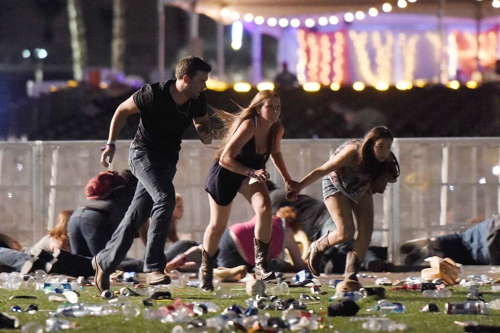 People run from the Route 91 Harvest country music festival after apparent gun fire was hear on October 1, 2017 in Las Vegas, Nevada. A gunman has opened fire on a music festival in Las Vegas, leaving at least 20 people dead and more than 100 injured. Police have confirmed that one suspect has been shot. The investigation is ongoing. (David Becker/Getty Images)