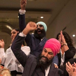 Jagmeet Singh, centre right, sits with his mother Harmeet Kaur, centre left, father Jagtaran Singh, left, and campaign manager Michal Hay, right, as it's announced he has won the first ballot in the NDP leadership race to be elected the leader of the federal New Democrats in Toronto on Sunday, October 1, 2017. THE CANADIAN PRESS/Chris Young