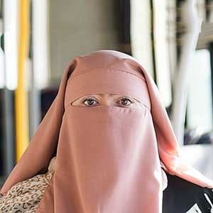 Warda Naili poses for a photograph on a city bus in Montreal, Saturday, October 21, 2017. Warda Naili says the first time she donned a niqab six years ago, it became a part of her. The Quebec woman, a convert to Islam, said she decided to cover her face out of a desire to practice her faith more authentically and to protect her modesty. THE CANADIAN PRESS/Graham Hughes