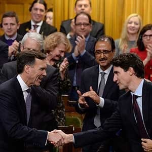 Finance Minister Bill Morneau shakes hands with Prime Minister Justin Trudeau after delivering his fall economic statement in the House of Commons in Ottawa, Tuesday, Oct.24, 2017. THE CANADIAN PRESS/Adrian Wyld