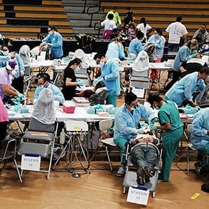 People wait to see a dentist at the Remote Area Medical (RAM) mobile dental and medical clinic on December 3, 2016 in Milton, Florida. It is expected that over a thousand people will show up seeking free dental and medical care at the two-day event in the financially struggling Florida panhandle community. RAM provides free medical care through mobile clinics in underserved, isolated, or impoverished communities around the country and world. As health-care continues to be a contentious issue in America, an estimated 29 million Americans, about one in 10, lack coverage. (Spencer Platt/Getty Images)
