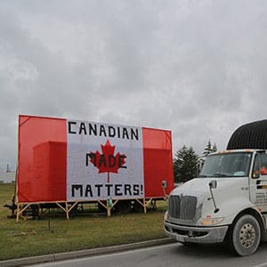 A truck passes a Canadian flag reading "Canadian Made Matters!" at a picket line of the auto workers union Unifor outside the General Motors Co (GM) CAMI assembly plant in Ingersoll, Ontario, Canada October 13, 2017. (Chris Helgren/Reuters)
