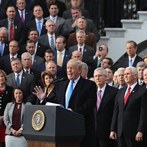 WASHINGTON, DC - DECEMBER 20: U.S. President Donald Trump, flanked by Republican lawmakers, celebrates Congress passing the Tax Cuts and Jobs Act on the South Lawn of the White House on December 20, 2017 in Washington, DC. The tax bill is the first major legislative victory for the GOP-controlled Congress and Trump since he took office almost one year ago. (Photo by Chip Somodevilla/Getty Images)