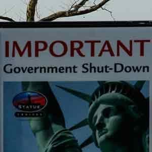 NEW YORK, NY - JANUARY 21: A Shutdown placard is seen at the entrance of the Liberty State ferry terminal as people look on in Battery Park on January 21, 2018 in New York City. The iconic landmark remains closed as part of the US government shutdown now entering its second full day after coming into effect at midnight on Friday after senators failed to pass a new federal spending bill. (Photo by Eduardo Munoz Alvarez/Getty Images)