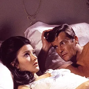 This undated publicity photo provided by United Artists and Danjaq, LLC shows jane Seymour, left, and Roger Moore, in the James Bond 1973 film, "Live and Let Die." Initially, Bond girls were part of the aesthetic of the series. They had more transient roles. The film is included in the MGM and 20th Century Fox Home Entertainment Blu-Ray "Bond 50" anniversary set. (AP Photo/United Artists and Danjaq, LLC)