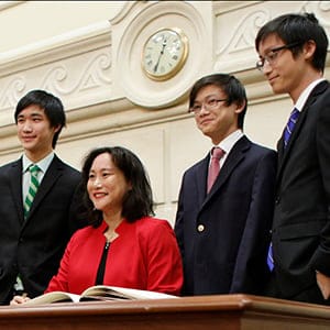 12:37 pm - Jean Yip poses with her sons Nathaniel (L), Theo and Ethan (R) after being sworn-in as an MP (Photograph by Blair Gable)