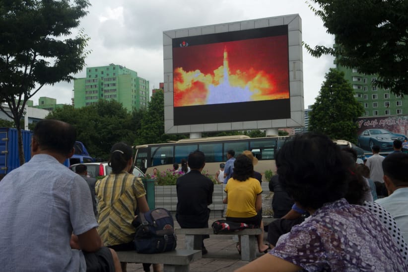 People watch as coverage of an ICBM missile test is displayed on a screen in a public square in Pyongyang on July 29, 2017. Kim Jong-Un boasted of North Korea's ability to strike any target in the US after a second ICBM test that weapons experts said on July 29 could even bring New York into range - in a potent challenge to President Donald Trump. (Kim Won-Jin/AFP/Getty Images)