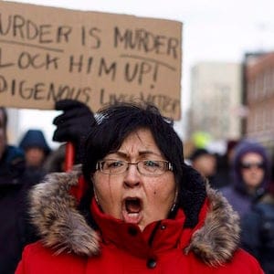 A marcher cries during a rally in response to Gerald Stanley's acquittal in the shooting death of Colten Boushie in Edmonton, Alta., on Saturday, February 10, 2018. THE CANADIAN PRESS/Jason Franson