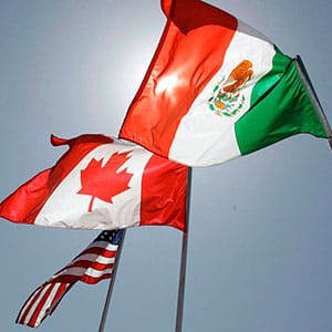In this April 21, 2008 file photo, national flags representing the United States, Canada, and Mexico fly in the breeze in New Orleans where leaders of the North American Free Trade Agreement met. THE CANADIAN PRESS/AP/Judi Bottoni