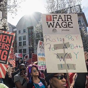 Demonstrators at the U.S. Labor Department headquarters building. Part of nationwide protests coinciding with International Women's Day and the Day Without a Woman. During the late afternoon rally that followed, speakers demanded an end to workplace violence and harassment, pay equity, one fair living wage, paid leave, and labor rights at the workplace. (Bob Korn/Alamy)