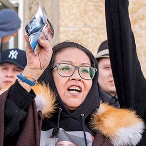 Debbie Baptiste, the mother of Colten Boushie, holds up a picture of her son as she leaves the Court of Queen's Bench during a lunch recess on the fifth day of the trial of Gerald Stanley, the farmer accused of killing the 22-year-old Indigenous man, in Battleford Sask., Monday, February 5, 2018. THE CANADIAN PRESS/Liam Richards