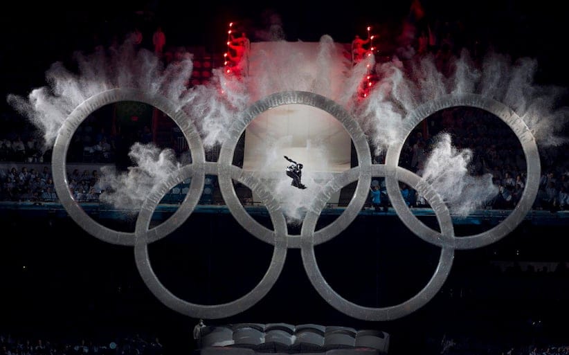 CORRECTED VERSION
A snowboarder flies through the Olympic rings at the beginning of the opening ceremonies for the XXI Olympic Winter Games in Vancouver, Friday, Feb. 12, 2010. THE CANADIAN PRESS/Jonathan Hayward