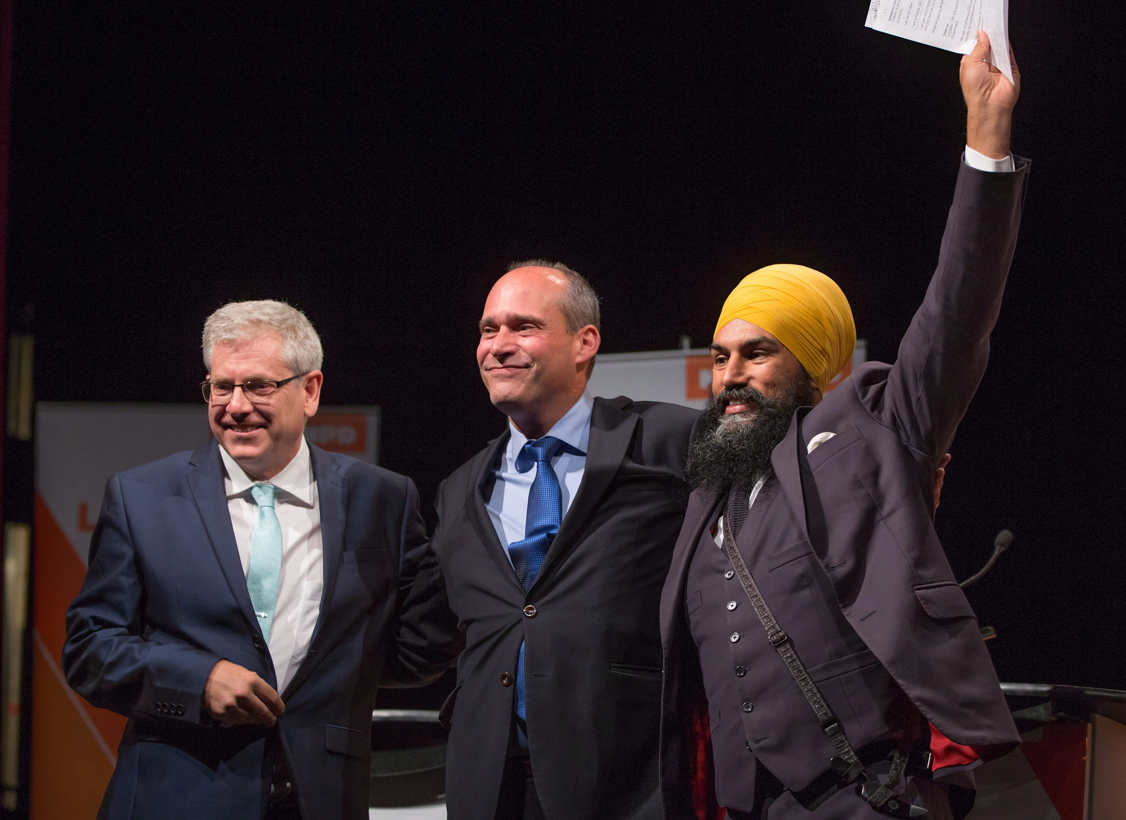 Charlie Angus, Guy Caron and Jagmeet Singh come together on stage after the final federal NDP leadership debate in Vancouver, B.C., on Sunday Sept. 10, 2017. (THE CANADIAN PRESS/Darryl Dyck)
