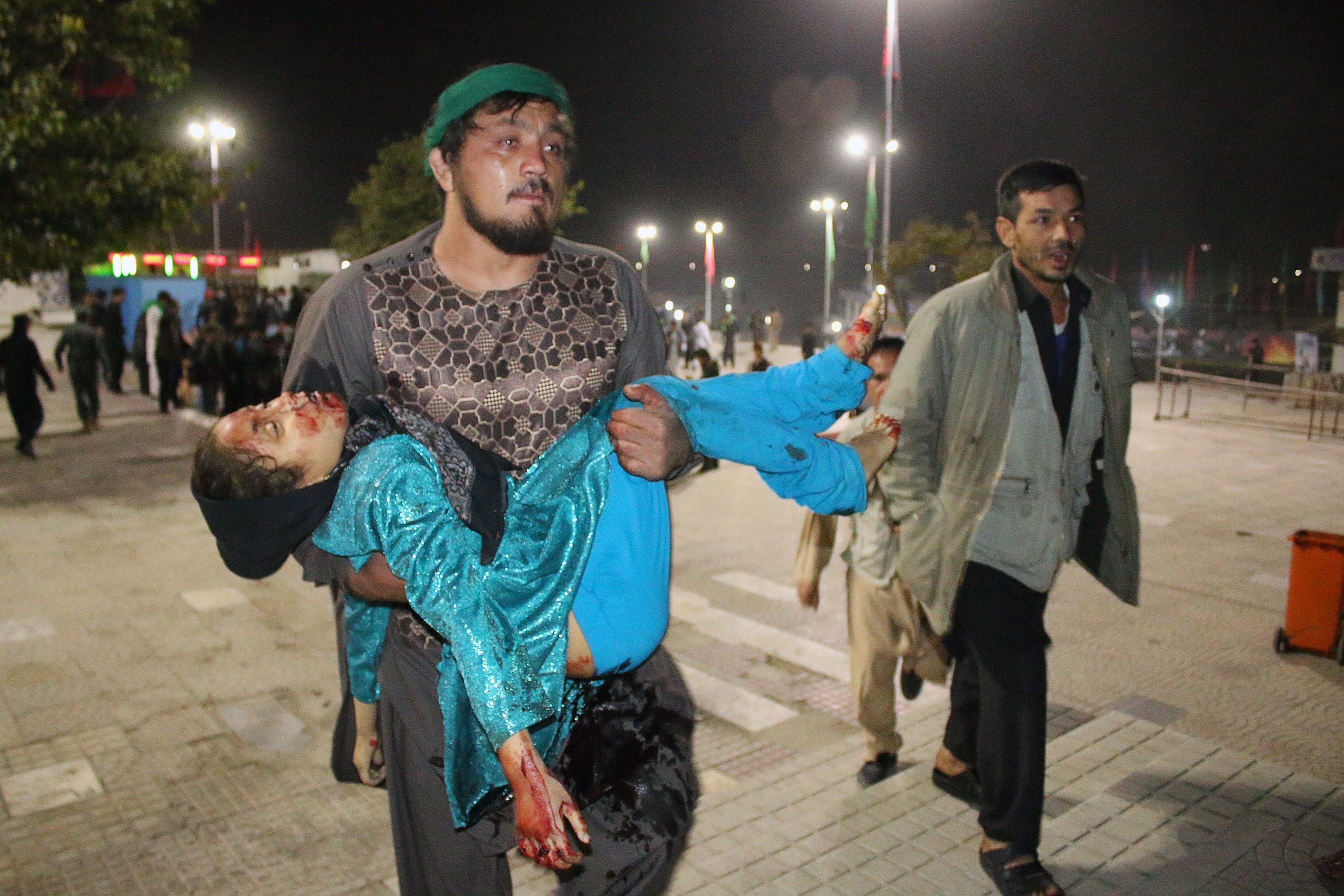 Wakil Hussain Allahdad carries a wounded girl after an attack by gunmen at the Karte Sakhi shrine in Kabul in 2016. Wakil was killed in a suicide bombing last Sunday.
(ROHULLAH AMIN/AFP/Getty Images)