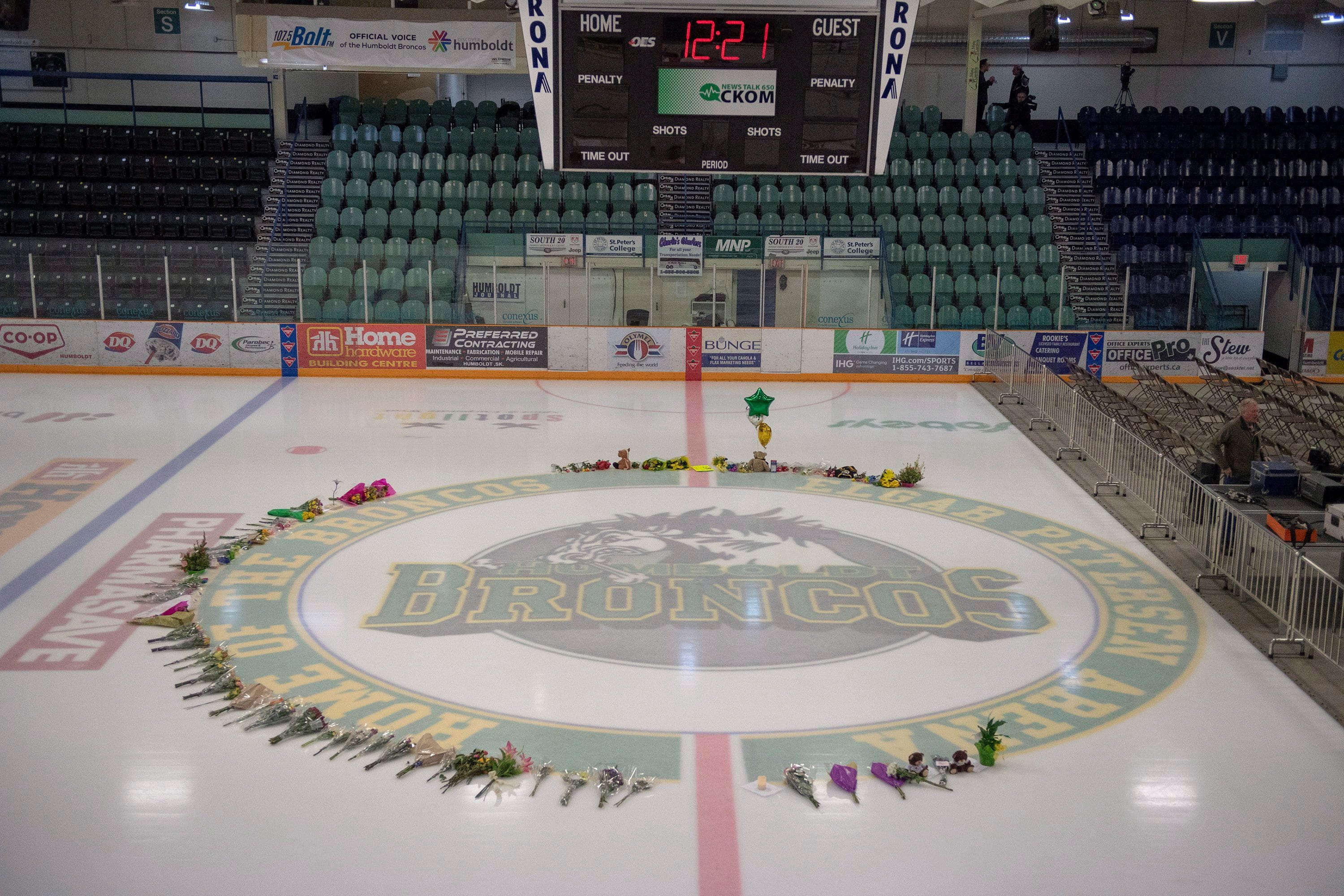 Flowers are shown at centre ice as preparations are made at Elgar Petersen Arena for a vigil tonight in Humboldt, Sask., Sunday, April 8, 2018. THE CANADIAN PRESS/Liam Richards