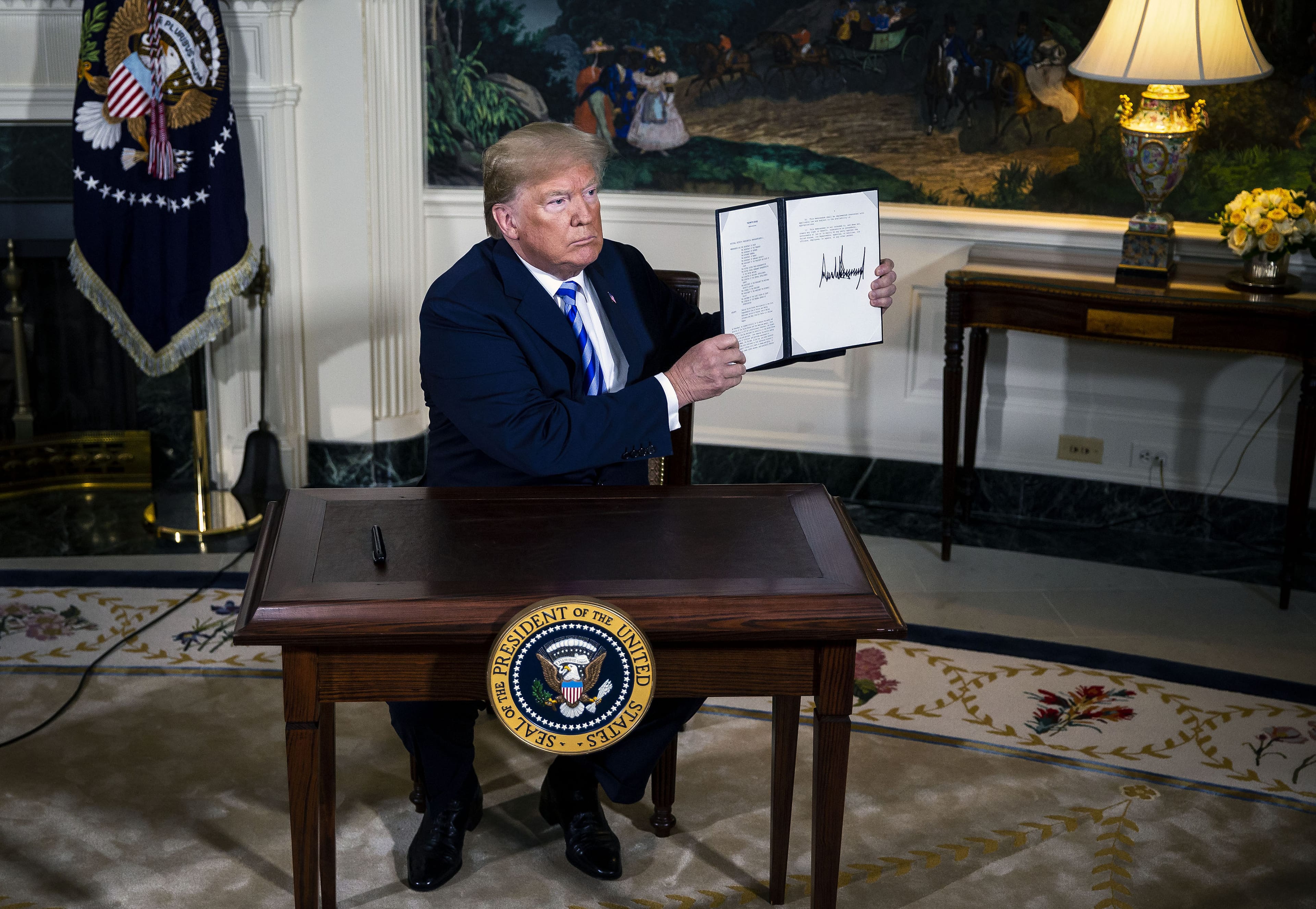 U.S. President Donald Trump displays a signed Presidential Memorandum on Tuesday, May 8, 2018, after stating the U.S. will withdraw from the landmark 2015 accord to curb Iran's nuclear program (Al Drago/Bloomberg via Getty Images)