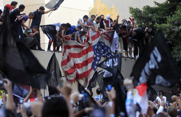 <p>Protesters destroy an American flag pulled down from the U.S. embassy in Cairo on September 11, 2012 over what they said was a film being produced in the United States that insulted Prophet Mohammad. (Mohamed Abd El Ghany/Reuters)</p>
