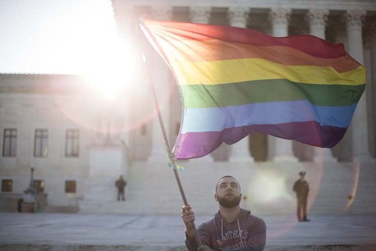 <p>A rainbow pride flag is waved near the U.S. Supreme Court in April, two months before same-sex marriage was declared a constitutional right (Drew Angerer/Getty Images) </p>
