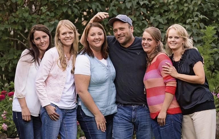 <p>Brady Williams poses with his wives, from left to right, Paulie, Robyn, Rosemary, Nonie, and Rhonda, outside of their home in a polygamous community outside Salt Lake City. The Williams are among an estimated 15,000 independent polygamists in the West that don&#8217;t belong to an organized fundamentalist Mormon church. (Rick Bowmer/AP)</p>
