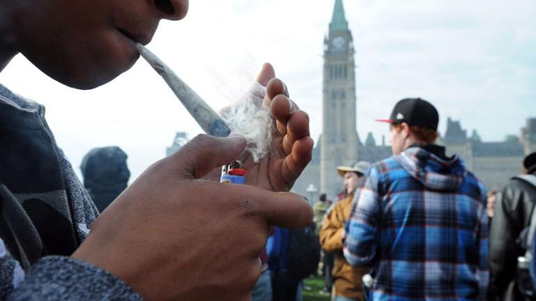 <p>A protester lights a joint during a 4-20 marijuana rally on Parliament Hill in Ottawa on Friday, April 20, 2012. (Sean Kilpatrick/CP)</p>
