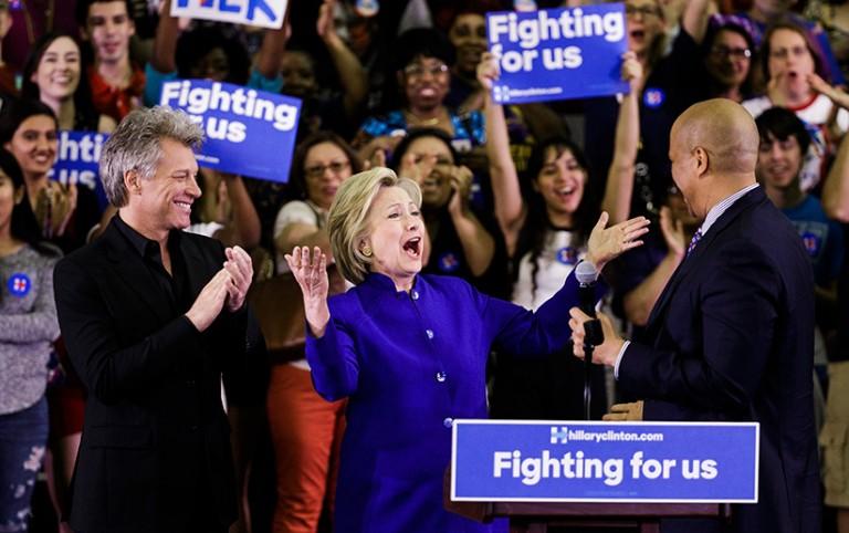 <p>Democratic presidential candidate Sec. Hillary Clinton (C) is introduced by US musician Jon Bon Jovi (L) and Sen. Corey Booker (R), of New Jersey, at a campaign rally at the Golden Dome Athletic Center at Rutgers University in Newark, New Jersey, USA, 01 June 2016. New Jersey is holding its primary on June 07, 2016.  (Justin Lane/EPA/CP)</p>
