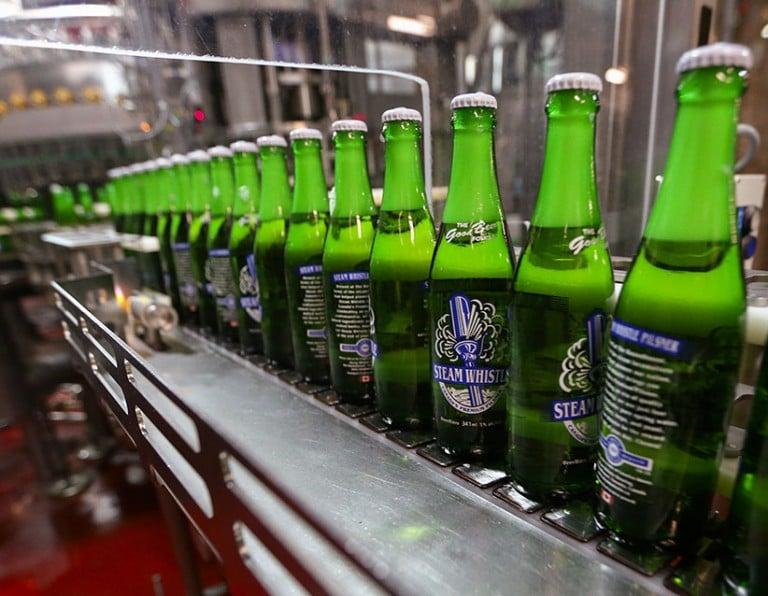 <p>Steam Whistle beer bottles move along the bottling line. (Rick Madonik/Toronto Star/Getty Images)</p>
