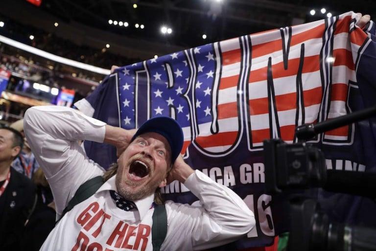 <p>Jake Byrd (a character from &#8216;The Jimmy Kimmel Show&#8217;)  reacts as New York delegate Bob Hayssen holds up a Trump flag during the second day session of the Republican National Convention in Cleveland, Tuesday, July 19, 2016. (AP Photo/John Locher)</p>
