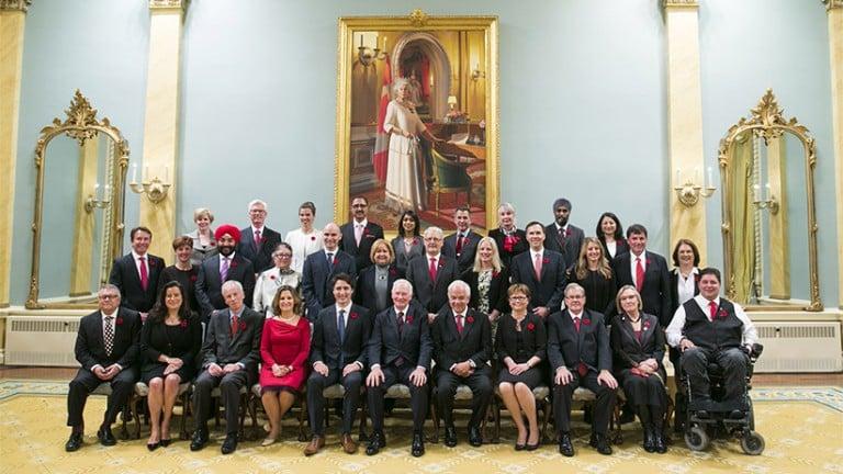 <p>Newly elected Canadian Prime Minister Justin Trudeau, fifth left first row, takes a group photo with his cabinet ministers at Rideau Hall in Ottawa, Canada, Nov. 4, 2015. Justin Trudeau was sworn in as Canada&#8217;s 23rd prime minister and named a 31-member cabinet here Wednesday.  (Chris Roussakis/Xinhua News Agency/Getty Images)</p>
