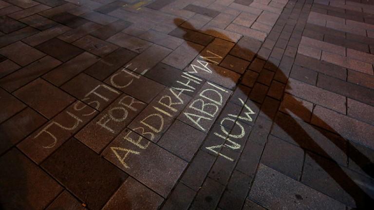 <p>A man casts a shadow near a message written in chalk during a vigil for Abdirahman Abdi, a Somali immigrant to Canada who died after being hospitalized in critical condition following his arrest by Canadian police, in Ottawa, Ontario, Canada, July 26, 2016. (Chris Wattie/Reuters)</p>
