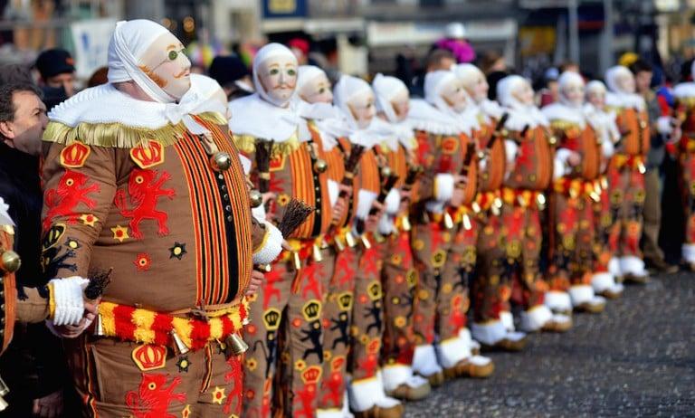 <p>&#8221;Gilles&#8221; in traditional costumes stand during the carnival in Binche, one of the most ancient and representative tradition of Wallonia (Eric Lalmand/AGP/Getty Images)</p>
