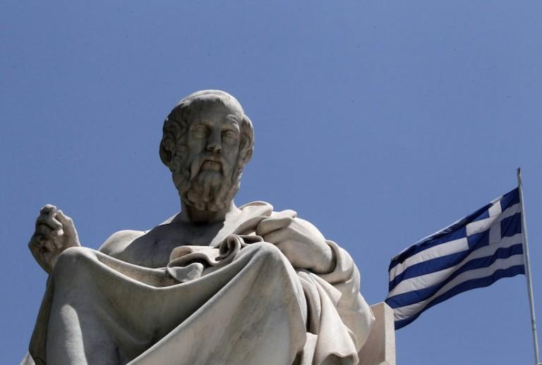 <p>The marble statue of the ancient Greek philosopher Plato stands in front of the Athens Academy, as the Greek flag flies in Athens on Tuesday June 5, 2012.  (AP Photo/Dimitri Messinis)</p>
