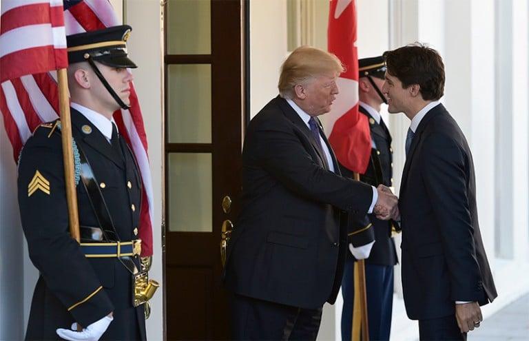 <p>US President Donald Trump (L) greets Canada&#8217;s Prime Minister Justin Trudeau upon arrival outside of the West Wing of the White House on February 13, 2017 in Washington, DC. (Mandel Ngan/AFP/Getty Images)</p>
