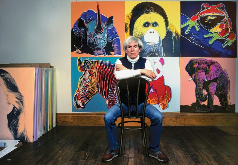 Warhol in 1983 at his studio, the Factory, with paintings from his Endangered Species series (Brownie Harris/Corbis/Getty Images)
